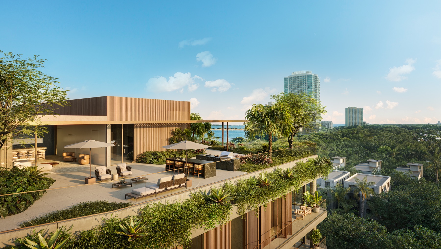 Outdoor lounge at Colette Residences at Brickell — an open-air gathering space with kitchen and barbecue area, embraced by lush landscaping.
